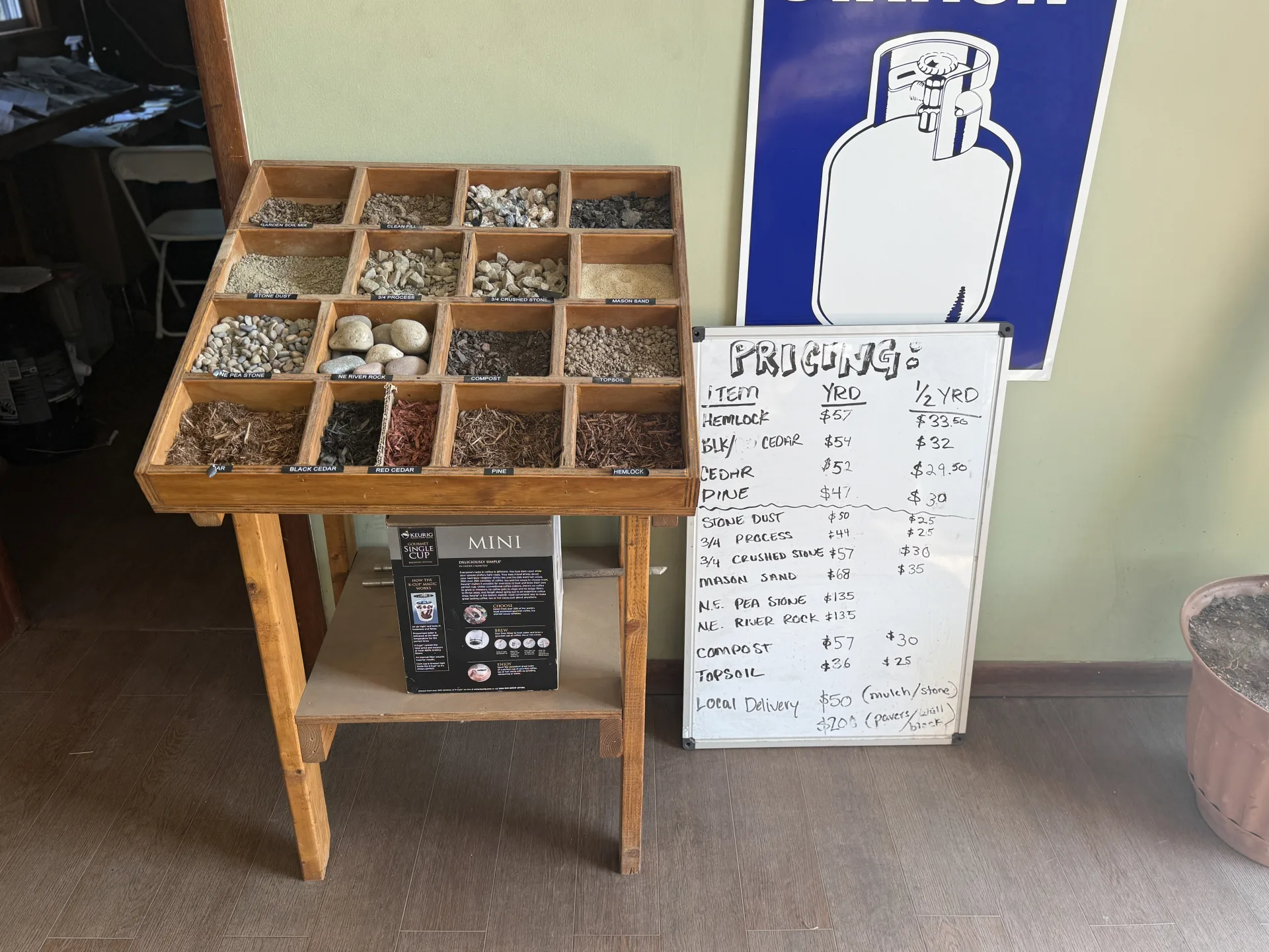 Stone, gravel and mulch sample display with pricing board at Evergreen Landscape Supply, Branford CT